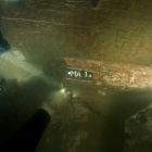 Découverte du mât de halage rangé dans le fond du caisson, sous le chargement de pierres. (Cliché T. Seguin ©  O'Can-Ipso Facto, Mdaa/CG13)